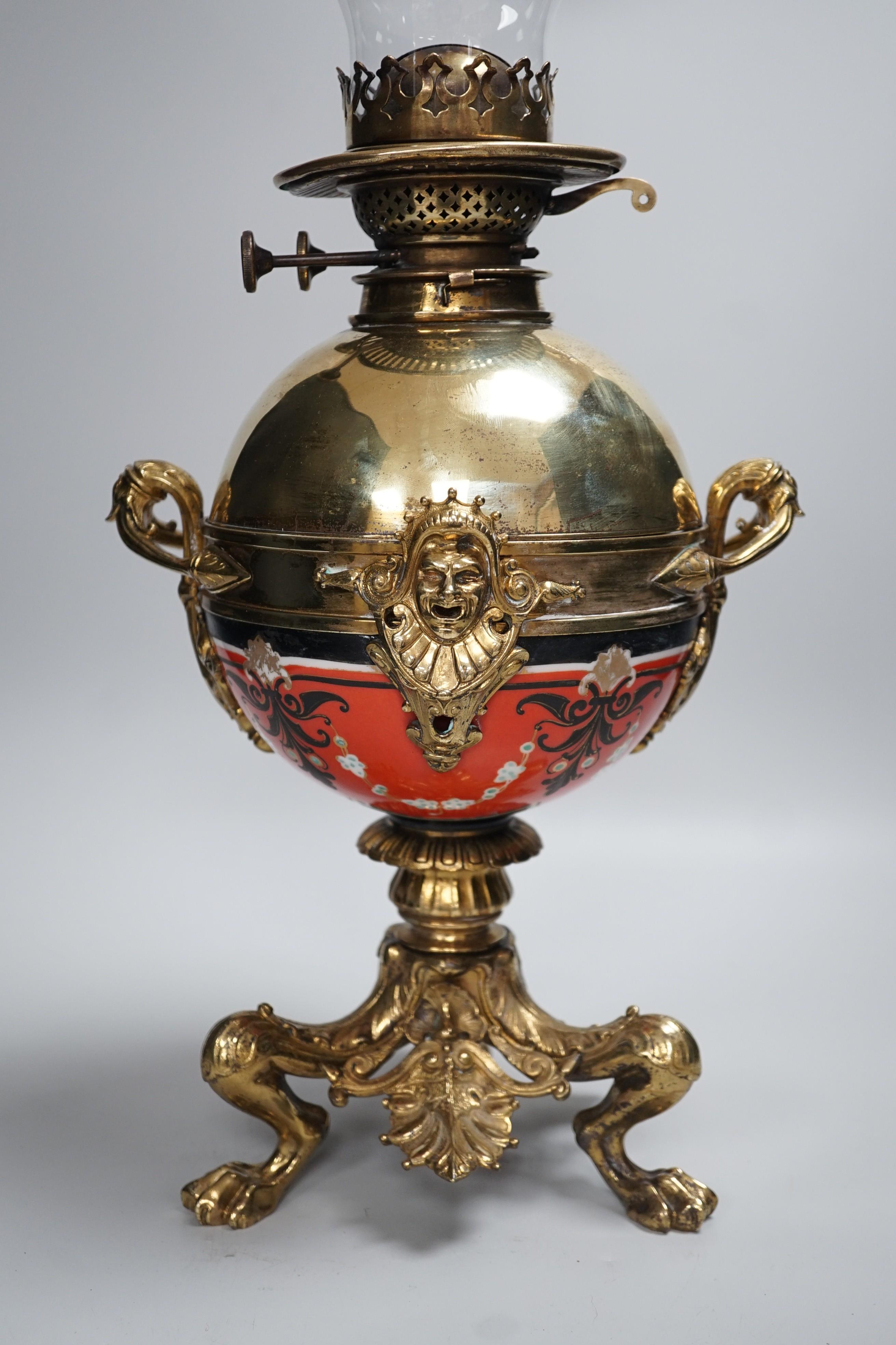 An early 20th century brass and porcelain oil lamp, 60cm total height